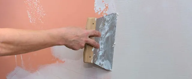 Painter scraping and prepping walls before painting - Schenectady, NY - VividPro Painters
